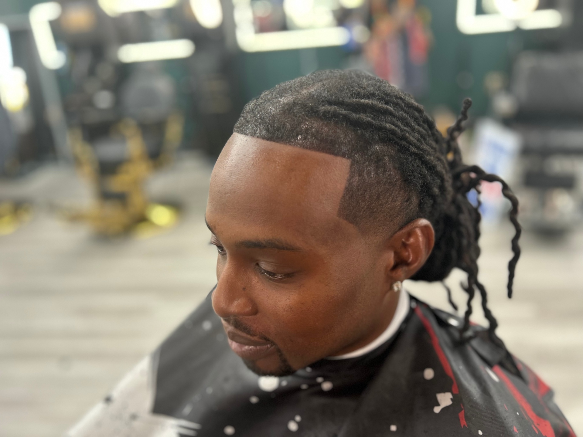 Barber giving a precision cut at Highbridge One in Bowie
