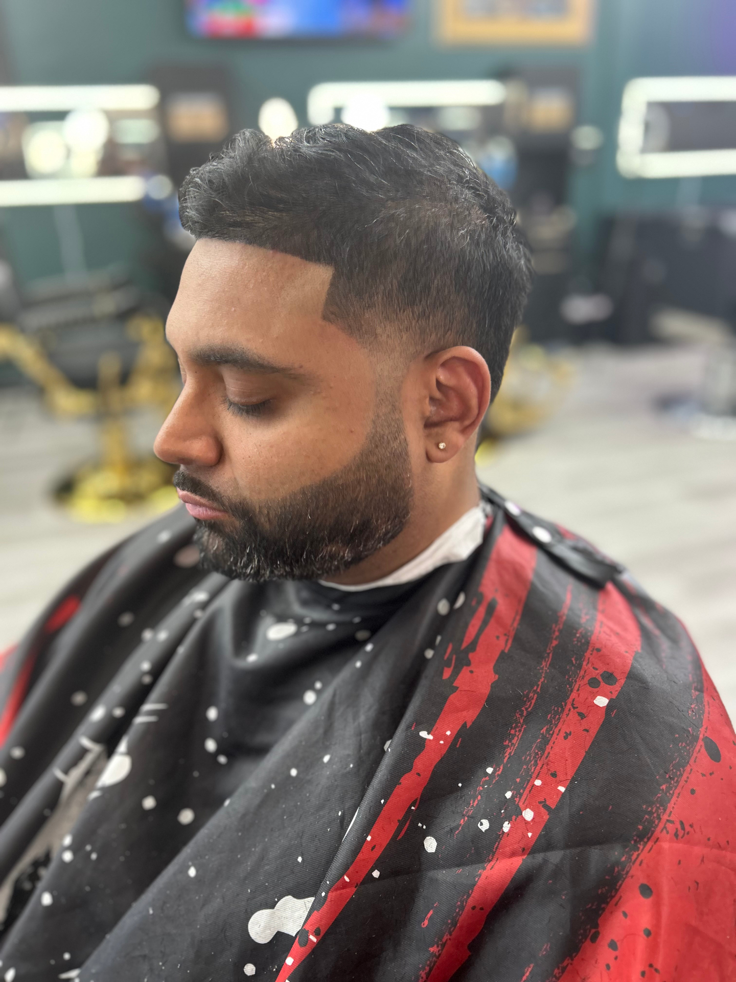 Barber working on a client in the Highbridge One lounge